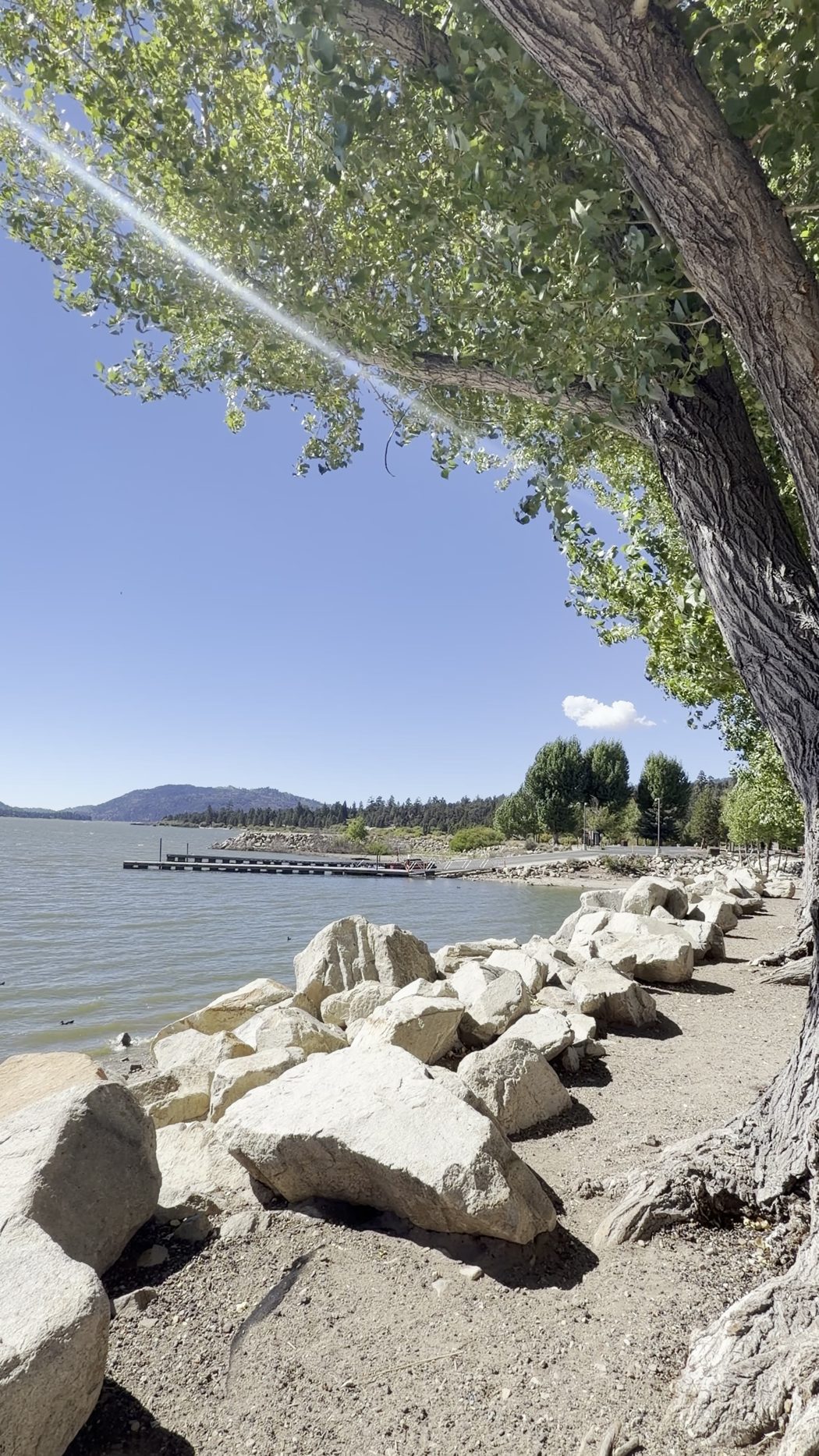 A rocky path along the shore of Big Bear Lake towards the boat launch dock
