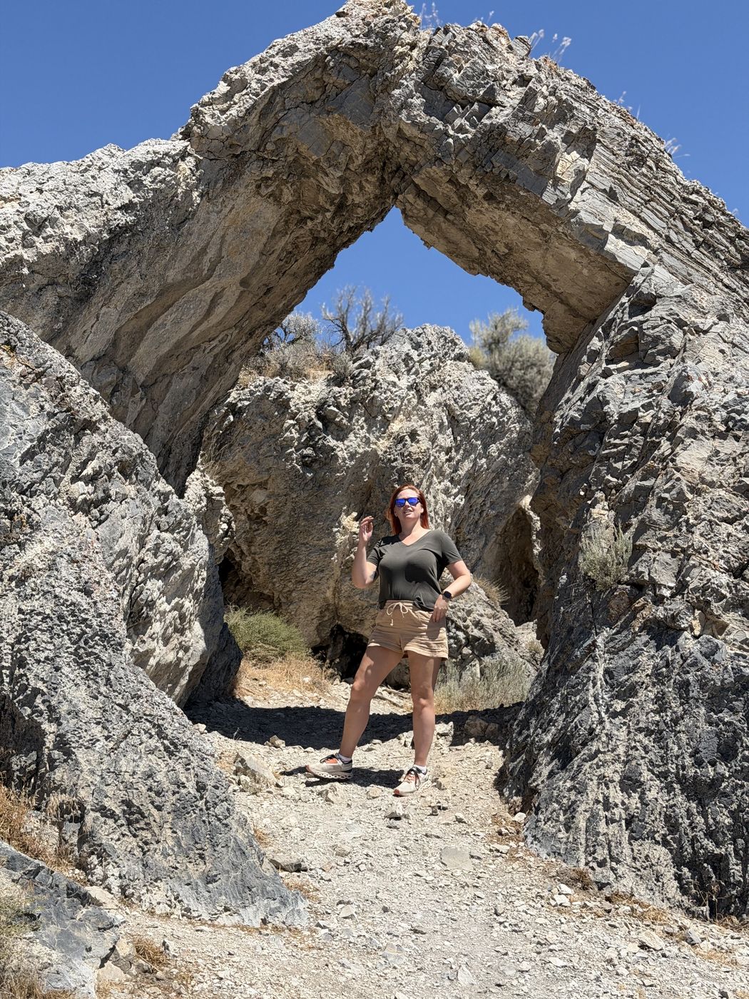 Jenna standing under the rock arch at Golden Spike