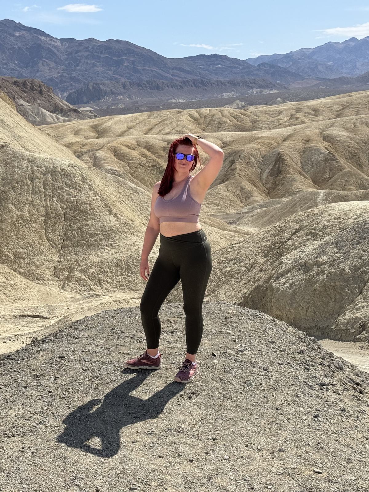 Jenna standing on a ridge in the Death Valley badlands