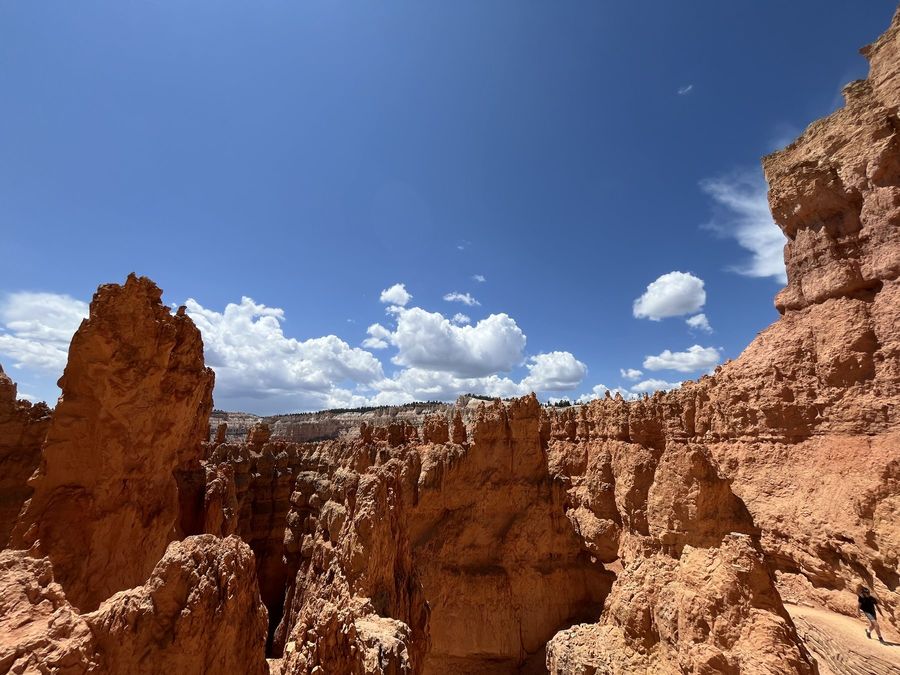 Red rock spires under bright summer clouds