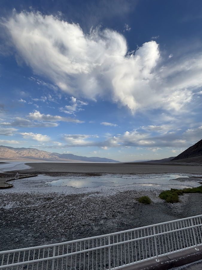 A heaped white cloud over the salt pools of a desert basin