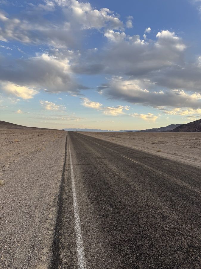 An empty two-lane road running straight to the horizon