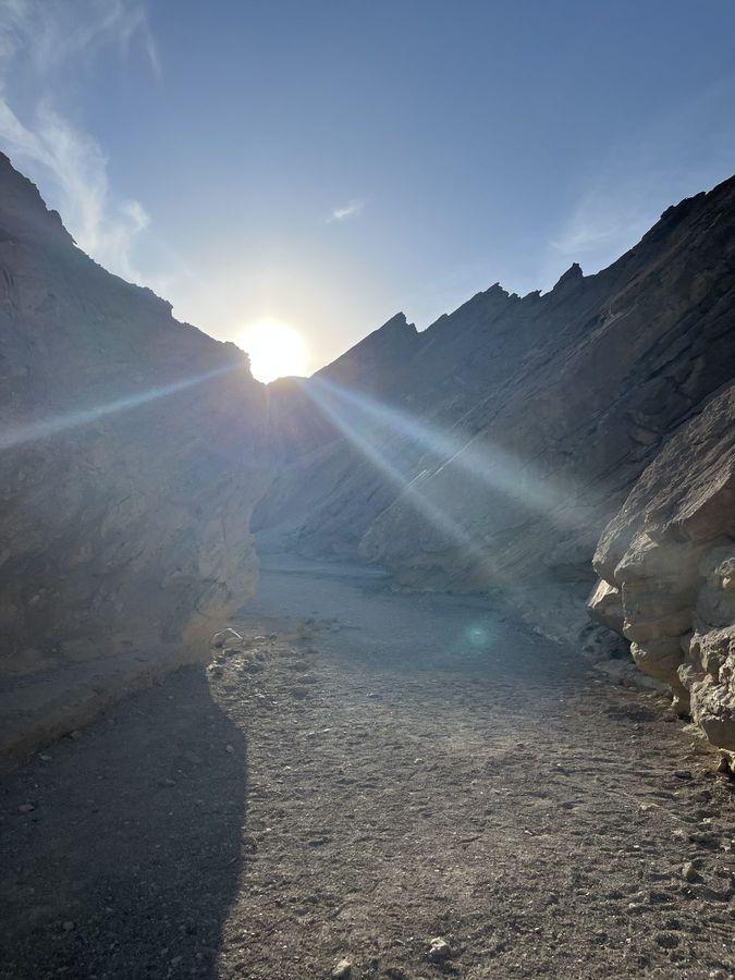 The sun breaking over a canyon ridge