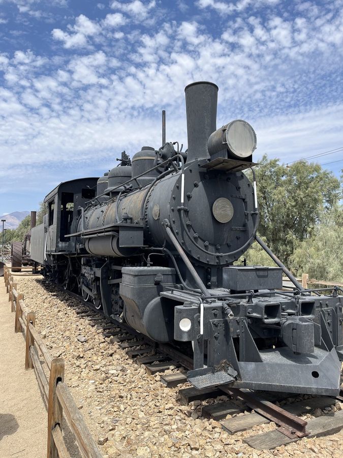 An old steam locomotive on display in the desert
