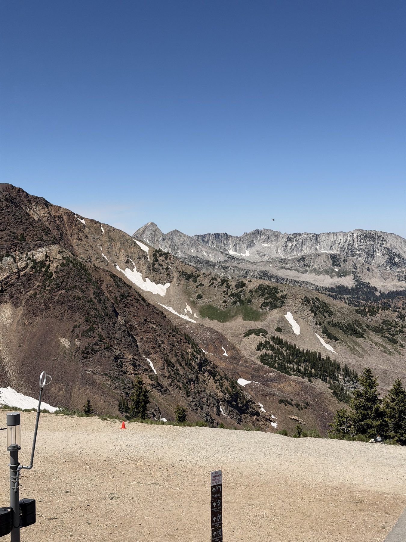 Snow-streaked peaks from a mountaintop deck in the Wasatch Mountains