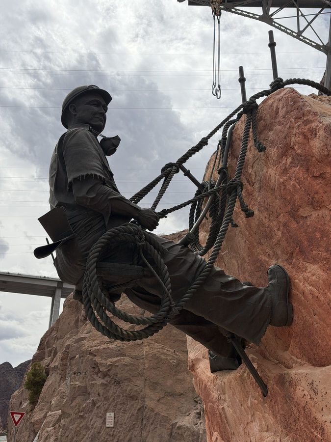 A bronze statue of a high scaler on the canyon wall at Hoover Dam