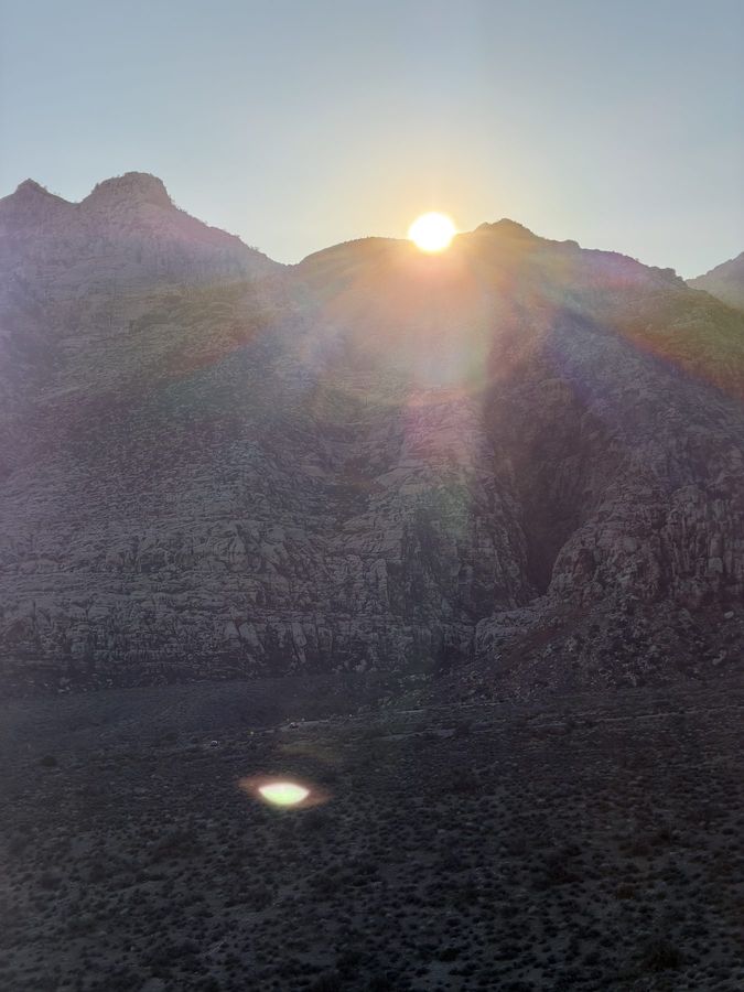 The sun rising over a mountain ridge